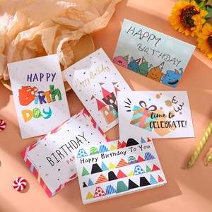 Set of six festive birthday cards with gold foil patterns and warm holiday greetings