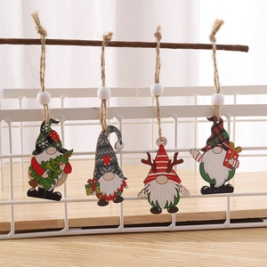 Set of four wooden Christmas gnomes hanging on a branch with rustic jute twine