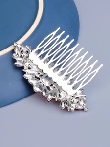 Detail of silver bridal hair comb with vintage red crystal leaf-shaped metal inlay