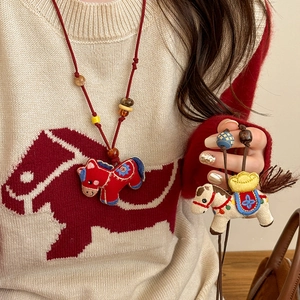 Handmade embroidered pony pendant necklace with wooden beads on a woven cord