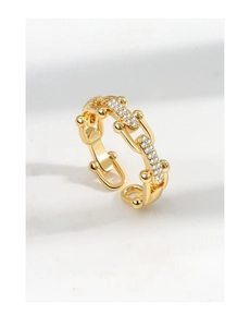 Detailed view of U-shaped gold ring with chain link design and sparkling crystal accents