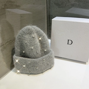 Detail shot of grey rabbit fur beanie with sparkling rhinestones and soft texture