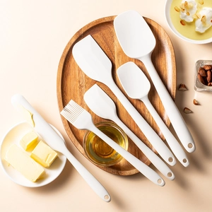 7-piece white silicone baking tool set with spatulas and oil brush on a wooden tray