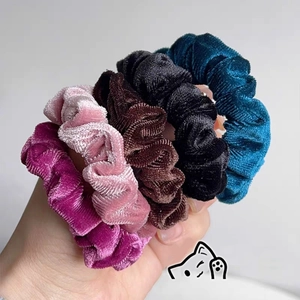 Close-up of colorful velvet scrunchies showing soft texture and high elasticity