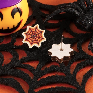 Detail showing Halloween spider web stud earrings with metal pins and orange pattern