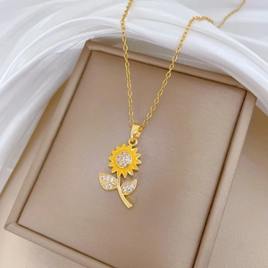Golden titanium sunflower necklace with yellow petals and sparkling crystals on white silk