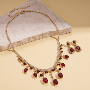 Vintage gold necklace and earring set with dark red square gems and fringe tassels