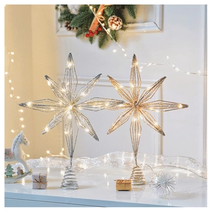 Detailed view of iron Christmas tree star topper with LED lights in gold and silver finish