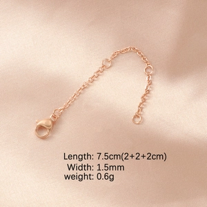 Rose gold adjustable extender chain with lobster clasp on pink satin background