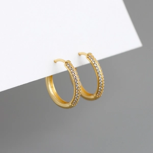 Detail of gold-plated hoop earrings featuring three rows of micro-pave white zircons