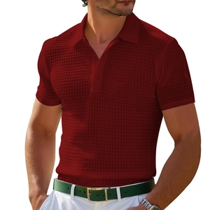 Close-up of red waffle knit polo shirt showing texture, buttoned collar and short sleeves
