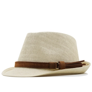 Detailed texture of woven straw fedora hat with brown suede band and metal ring accent