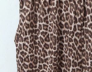 Detailed macro view of the classic leopard print pattern on elastic knit fabric