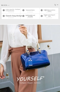 Close-up of bright blue patent leather handbag with gold metal buckles and woven handle
