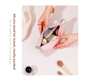Pink waterproof PU cosmetic bag open showing large capacity for skincare and makeup products