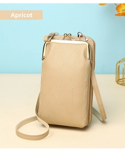 Detail view of apricot mini crossbody phone bag with V-shaped stitching and golden clasp