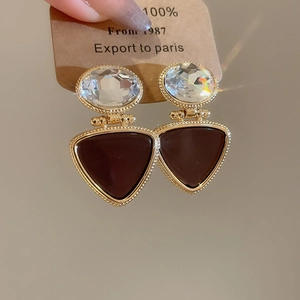 Detailed macro of 18k gold plated triangle drop earring with sparkling zircon insets