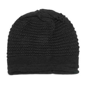 Detailed view of black striped knit beanie showing the thick ribbed texture and elastic hem