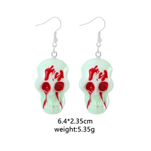 Detailed view of skull earrings with dimensions 6.4x2.35cm and 5.35g weight spec