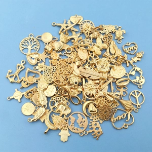 Assorted gold alloy charms including tree of life and stars for DIY jewelry making