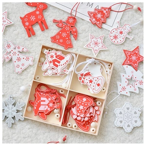 Detail of assorted wooden Christmas ornaments with red and white paint on white plush rug