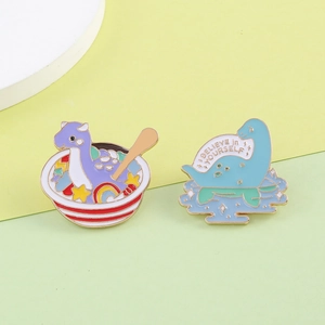 Cute cartoon dinosaur and Loch Ness monster enamel brooches with Believe in Yourself text