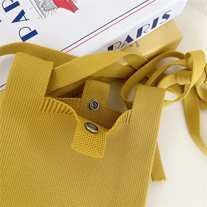 Vibrant yellow knitted crossbody phone bag with metal snap button and soft texture