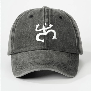 Close-up of the Coquí frog embroidery on grey washed cotton baseball cap texture