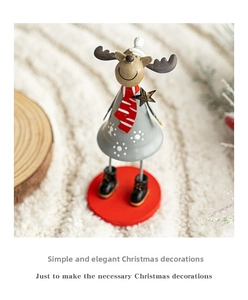 Detailed view of grey metal reindeer bell ornament with red scarf and snowflake patterns