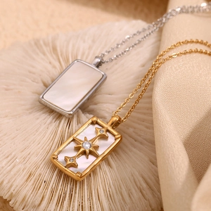 Detail of octagram tarot necklaces with white shell inlay in gold and silver finish