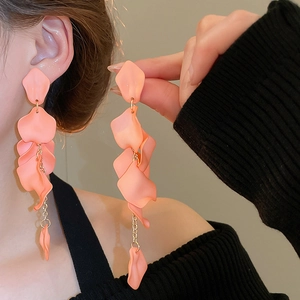 Detail of pink rose petal tassel earrings showing long floral fringe and matte texture