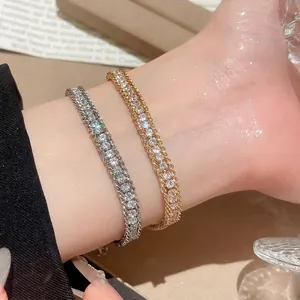 Sparkling tennis chain bracelet with diamond accents in gold and silver finishes