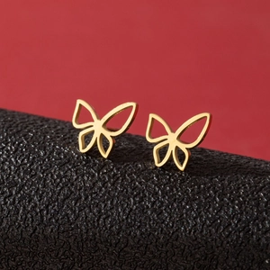 Minimalist hollow butterfly stud earrings in gold finish over a red and black background