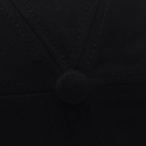 Detail of baseball cap top showing cotton twill fabric and double stitching work