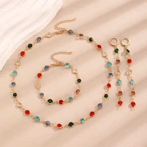Colorful zircon jewelry set with necklace, bracelet and earrings on beige background