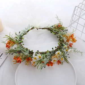 Detail of bridal floral crown with white daisies orange flowers and silk ribbons