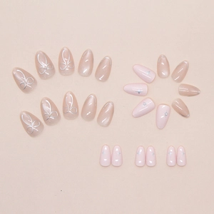 Close-up detail of 24pcs pink cat-eye press-on nails featuring bows, stars, and pearls