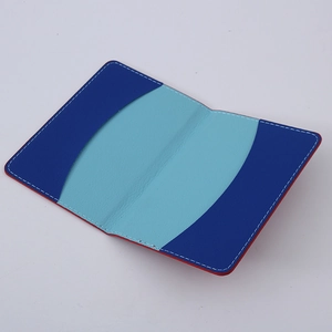 Blue bi-fold PU leather passport holder with card slots and red painted edges