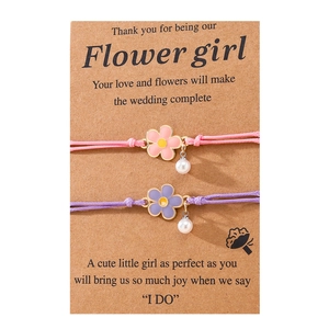 Detailed view of woven bracelets with flower charms and pearls on Flower Girl gift cards