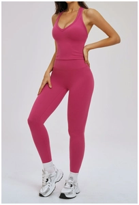 Detail of high-waisted yoga leggings and V-neck tank top in vibrant rose red sport set