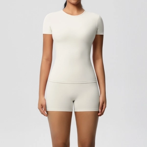 Front view of a slim fit cream yoga set featuring a crew neck T-shirt and high waist shorts
