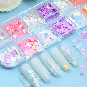 Macro shot of colorful 3D flower and butterfly nail art sequins in a 12-grid storage box