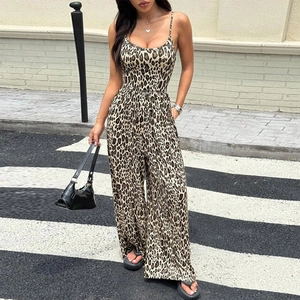 Chic leopard print backless jumpsuit with wide leg design worn by a model in street style