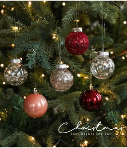 Close-up of 5cm Christmas ball ornaments in red and silver on a festive tree branch