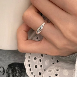 Close-up of S925 silver smiley face open ring featuring irregular retro letter design