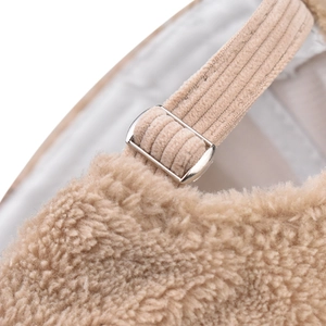 Detail of sherpa texture with corduroy strap and silver metal buckle on the cap