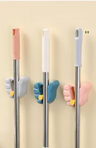 Detail of adjustable wall-mounted mop holder in grey and blue for various handle sizes