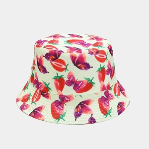 Detailed pattern of red strawberries and purple butterflies on reversible sun bucket hat