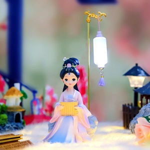 Macro shot of ancient style lady figurine with glowing lantern ornament on desk