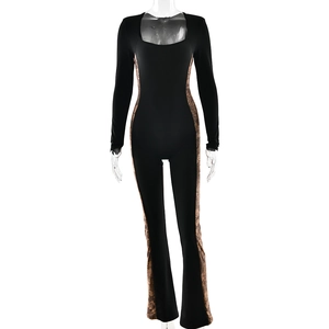 Black square neck jumpsuit with lace paneling and flared legs on a white background